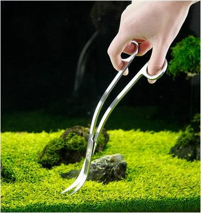 Aquarium grass scissors in hand with stainless wave-shaped blades
