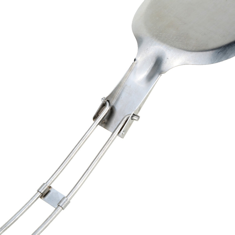 Close-up of stainless steel folding hinge and two-piece wire handle on cooking shovel.