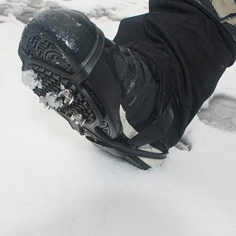 Ice cleat shoe cover stepping in snow, black rubber with metal spike studs for traction.