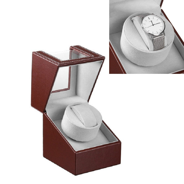 Single brown leather watch shaker box, open with white watch cushion
