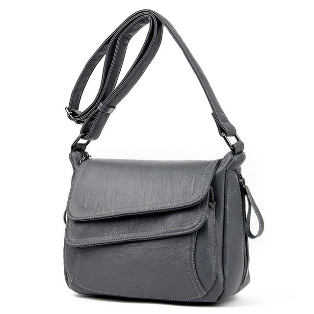 Gray leather shoulder messenger bag with flap front and adjustable strap