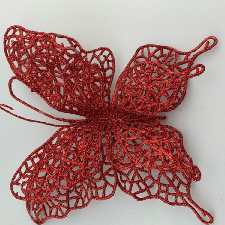 Red filigree butterfly Christmas ornament with lace-like textured wings and loop