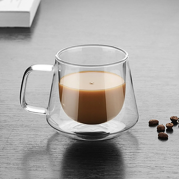 Double-wall glass coffee mug with clear handle, filled with dark coffee
