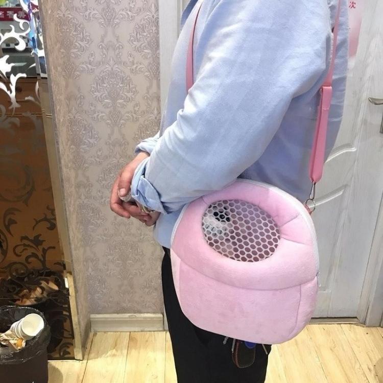 Pink pet carrier bag with round mesh opening, carried on shoulder