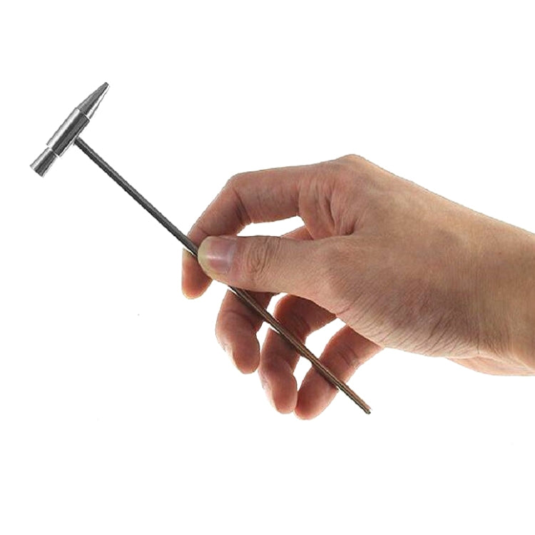 Mini tuning hammer held in hand; metal shaft with small conical head