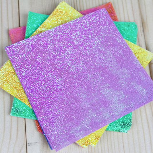Square glitter folding paper sheets with a large purple sheet and teal accents