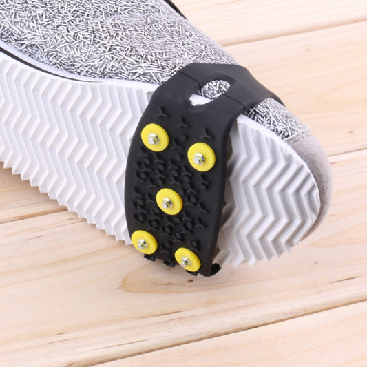 Black ice cleat shoe cover with five yellow traction pads on stud base