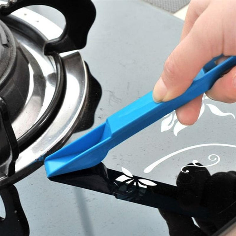 Mini cleaning brush and dustpan for corners, blue tool with black insert over surface