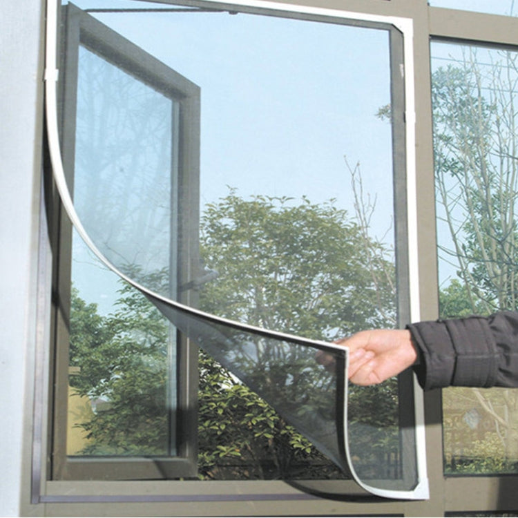 Black insect screen mesh curtain fitted over window, hand adjusting edge