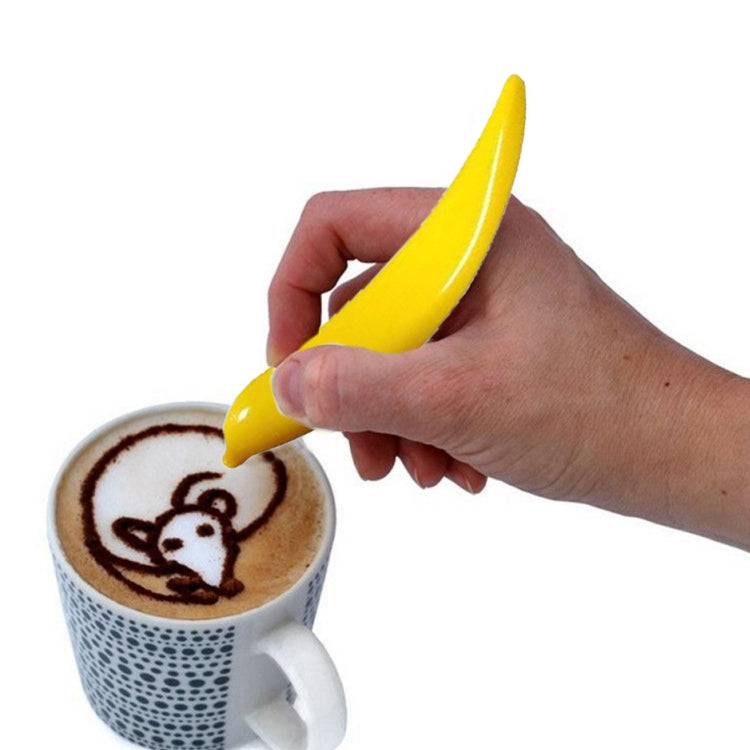 Electric latte art pen, yellow tip held over cup with latte drawing