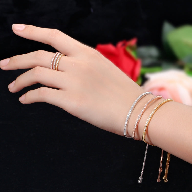 Adjustable silver zircon curved bracelet with dangling charms on wrist