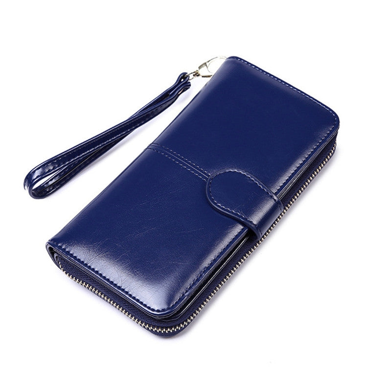 Dark blue long zip-around leather wallet clutch with wrist strap and stitched front pocket