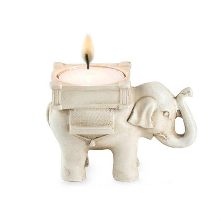 Beige elephant tea light candle holder figurine holding a round tea light