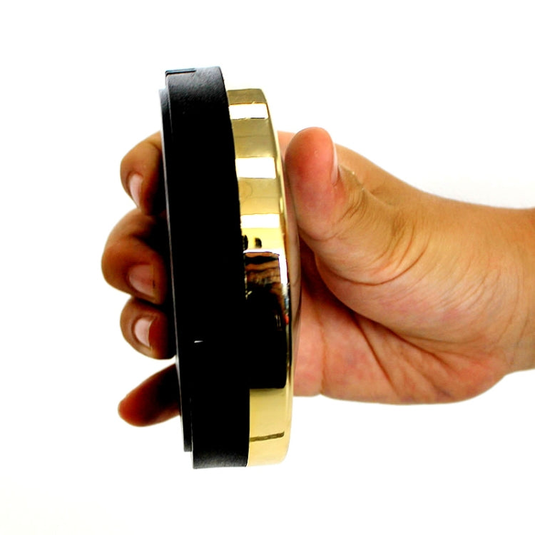 Thermo-hygrometer side view with black band and gold housing, held in hand