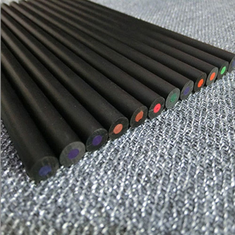 Black color pencils with colored tips arranged diagonally on textured fabric