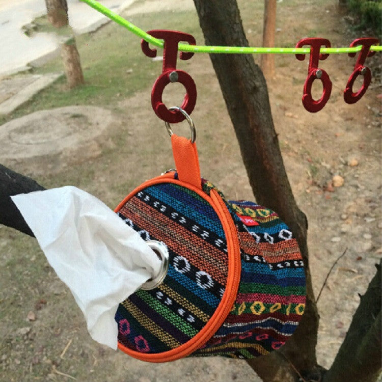 Red T-shape self-locking carabiner hook clipped to a patterned strap loop