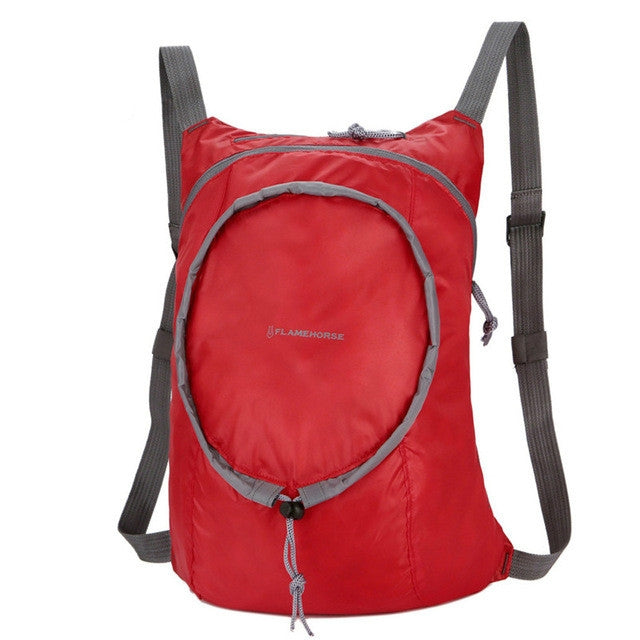 Red nylon waterproof collapsible backpack with front zip pocket and adjustable straps