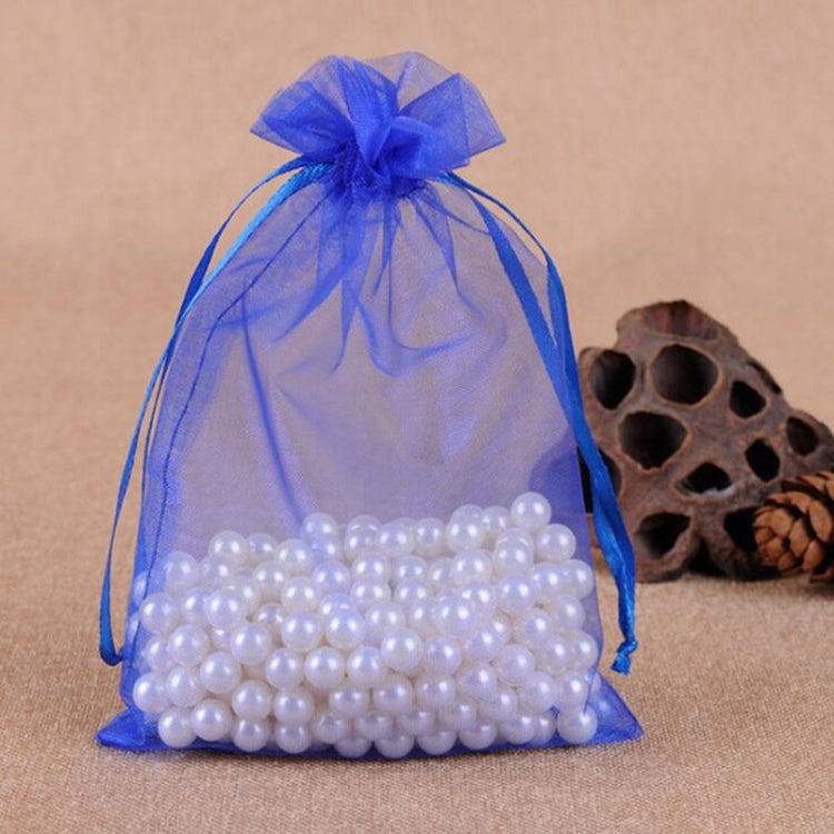 Blue organza jewelry gift pouch with drawstring and white bead bracelet inside