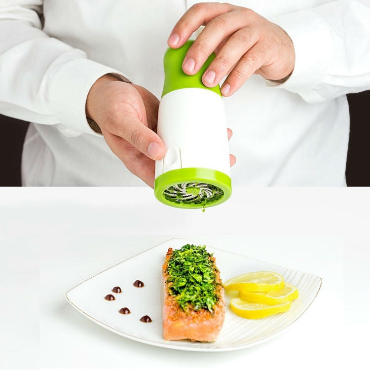 Handheld herb chopper over a plate, seasoning food with chopped greens