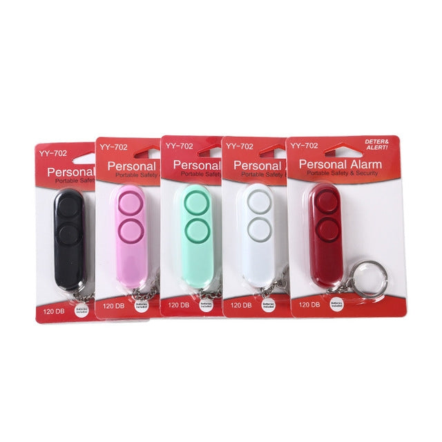 Assorted alarm keychain fobs in retail packages with 120 dB labels