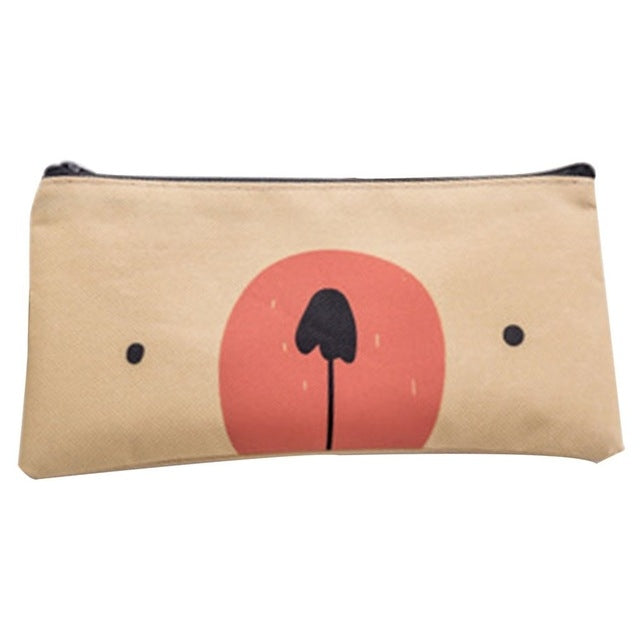 Tan cartoon dog pencil pouch with red sun and black tree graphic, top zipper