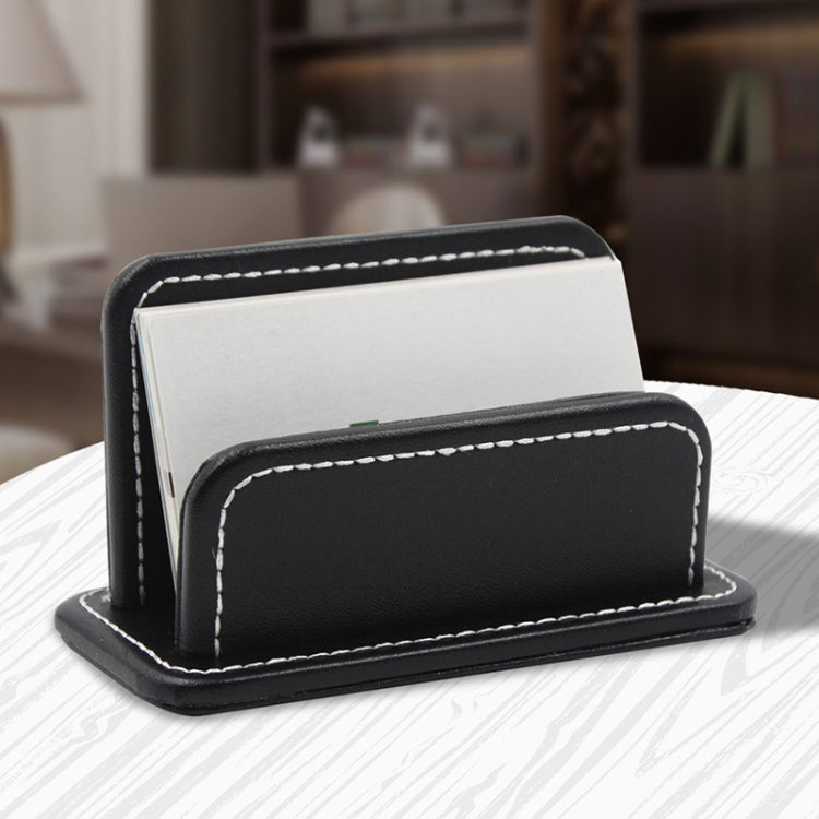 Black leather name card holder set with stitched fronts; cards tucked in the slots