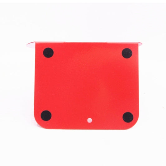 Red metal bookend panel with black circular dots, musical-note shape support