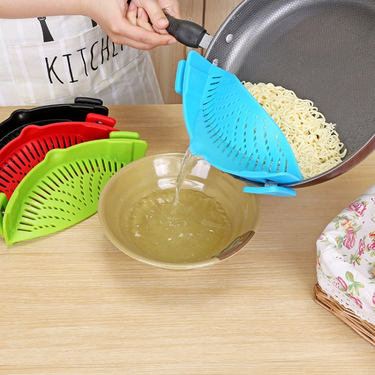 Blue silicone pot filter clip draining cooked pasta from a pan into a bowl