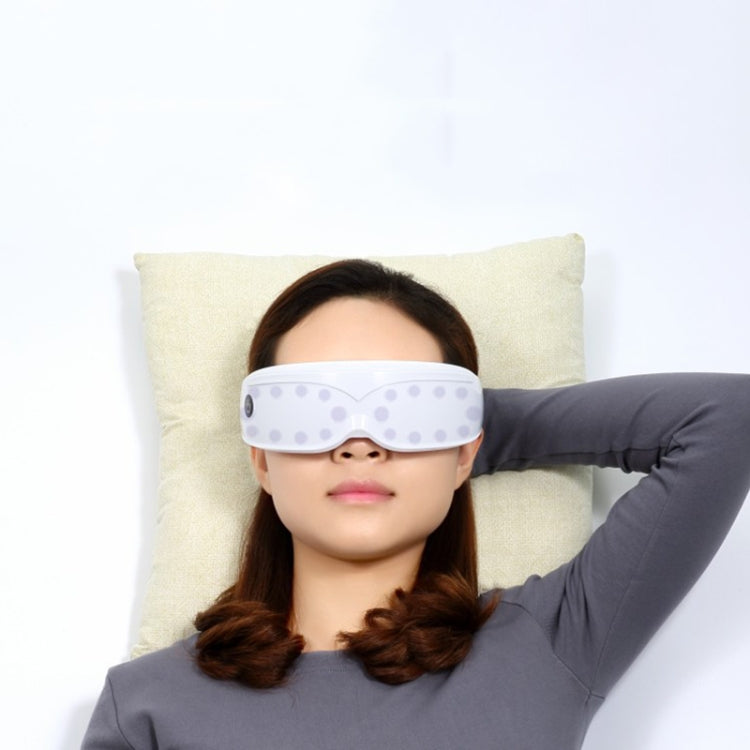 Eye massage device worn with light purple tinted visor and black head strap