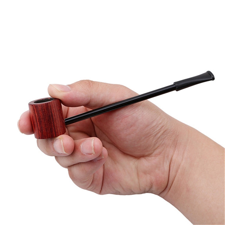 Portable wooden smoking pipe with textured bowl and long black stem, held in hand