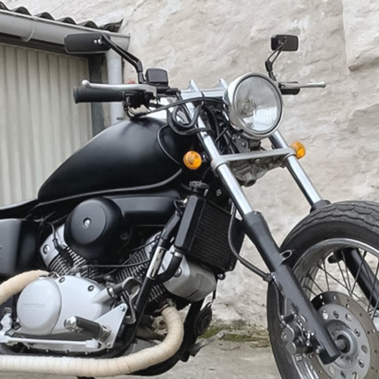 Anti-glare square rearview mirror mounted on a motorcycle handlebar