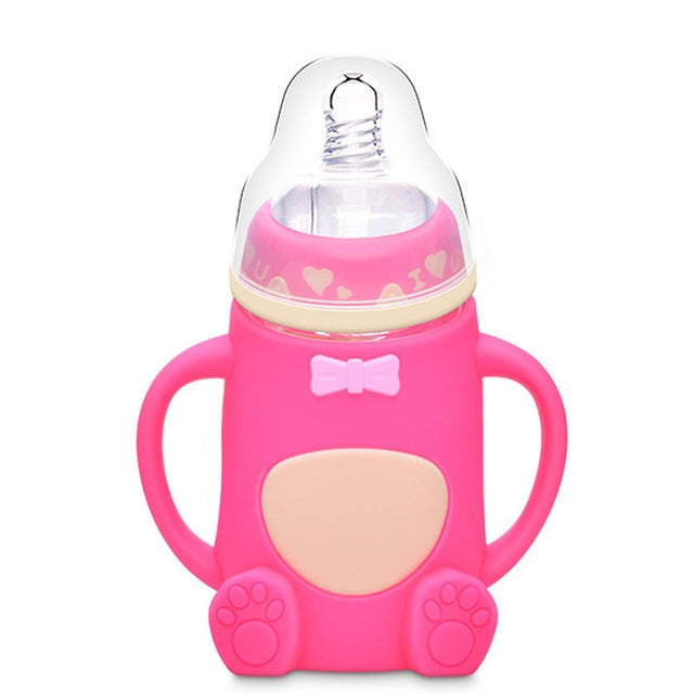 Hot-pink baby silicone-handled glass bottle with pink collar, bow, heart, and paw grips