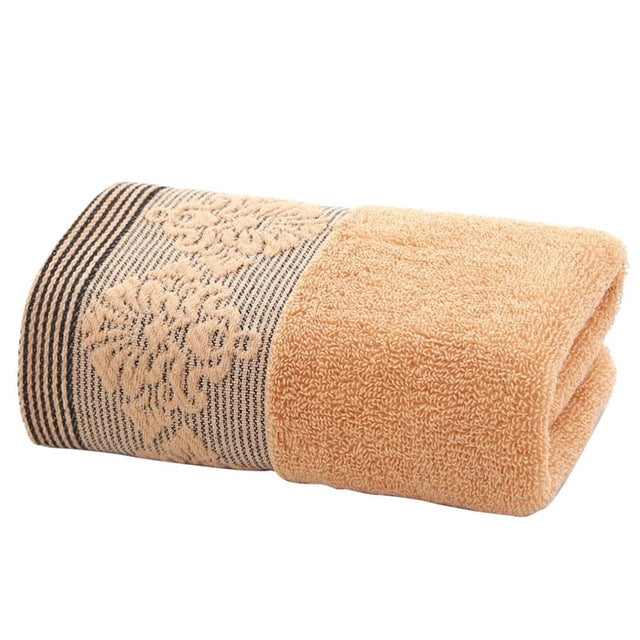 Thick peach face towel with dark tan striped floral border, soft terry, 35x75cm