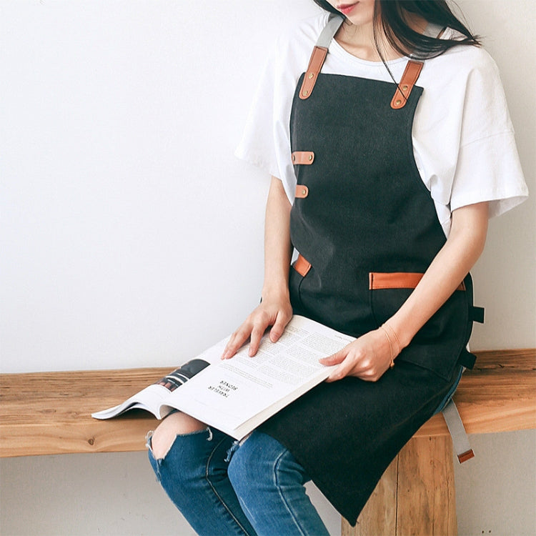 Dark green washed canvas apron with leather-look straps and front pocket