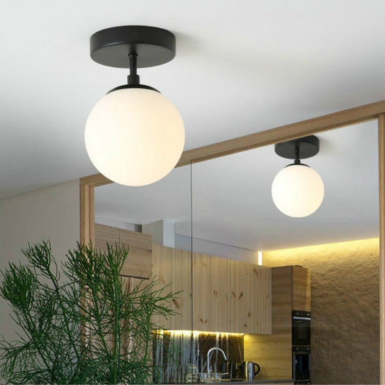Pair of black ceiling lamps with frosted globe shades and round mounts