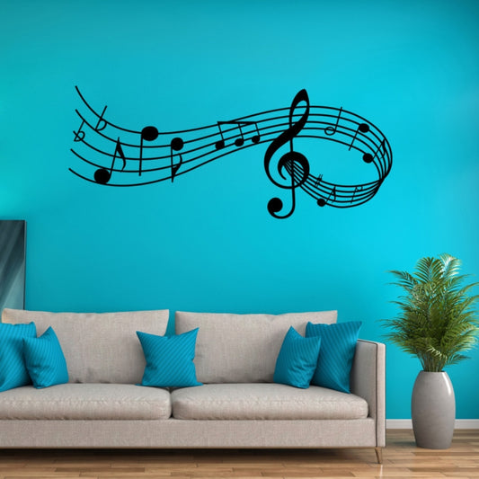 Black music note wall decal with treble clef and curved staff lines on a blue wall