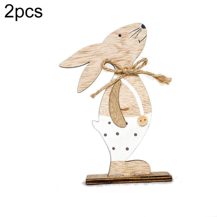 Wooden bunny ornament with white apron, twine bow, and small button detail on base