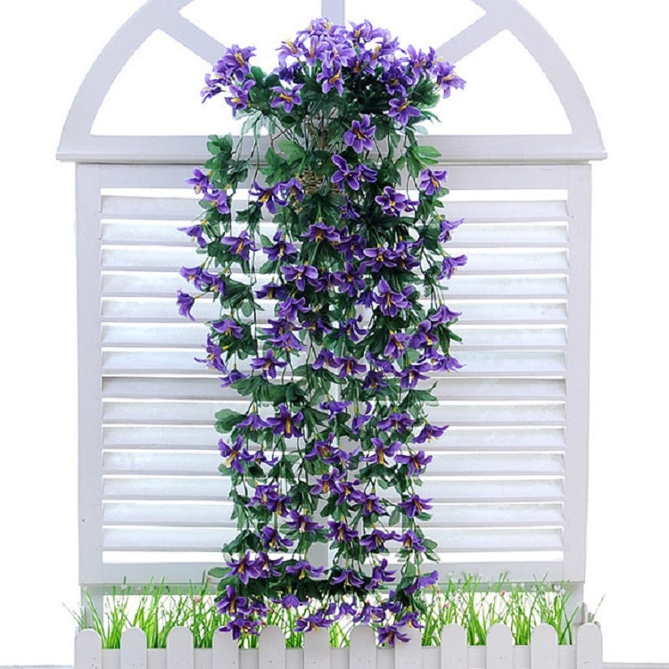 Artificial purple lily flower vine basket wall hanging with dense leafy greenery