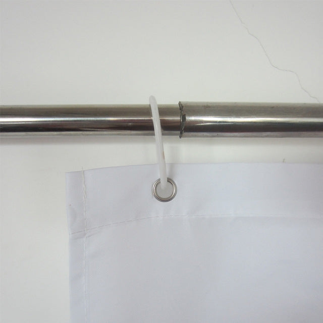 White shower curtain header with metal grommet for hanging on a rod