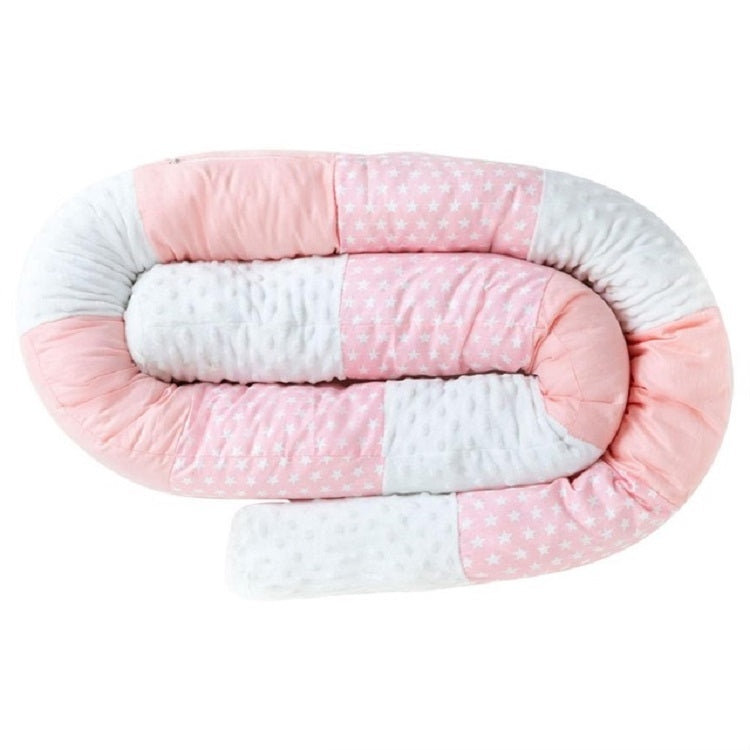 Cylindrical crib bumper with pink star fabric and pale padding panels
