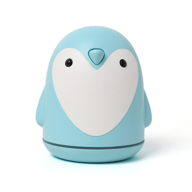 Light blue penguin USB aroma humidifier diffuser with rounded base and black eyes.