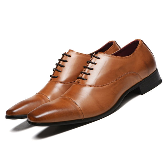 Tan leather oxford dress shoes with lace-up closure and black outsole