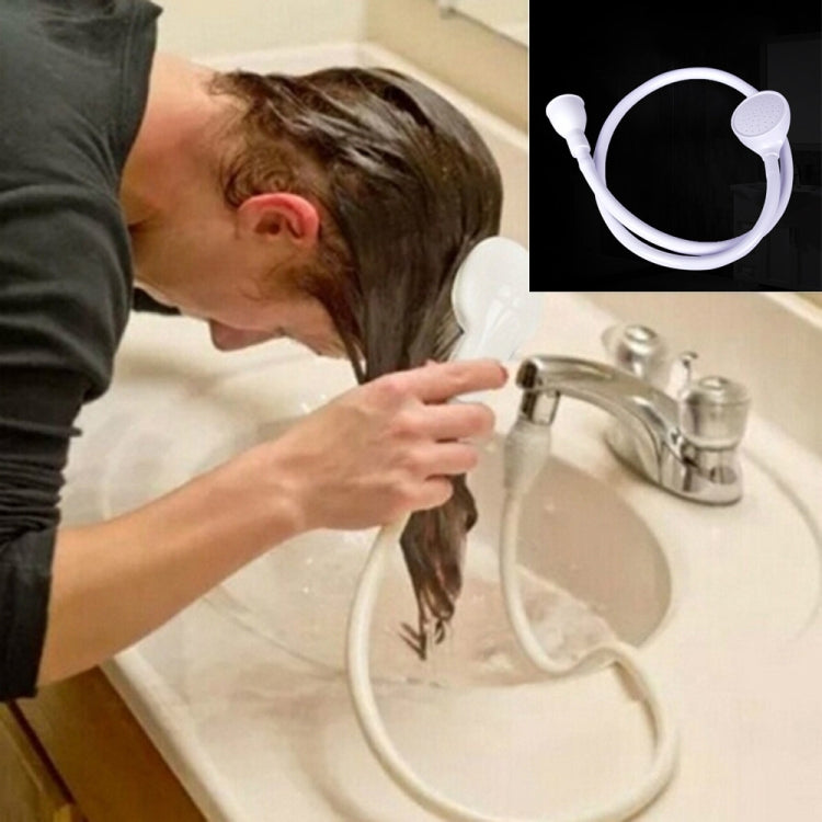 White sink pet shower hose with spray head, held over washbasin