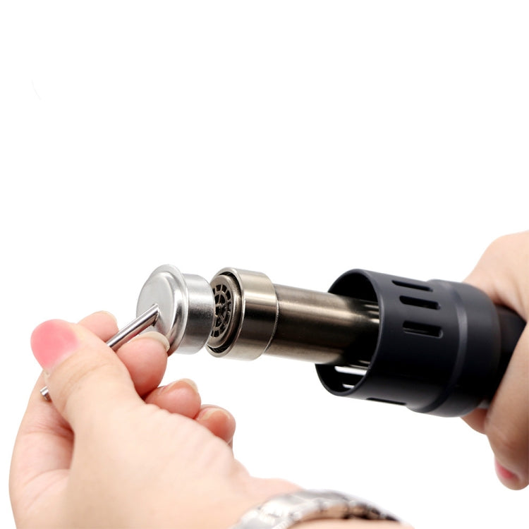 Hand holds hot air gun nozzle with angled chrome tip for heat work