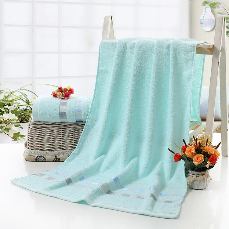 Cotton bath towel in light blue with checkered stripe border and plush loop pile