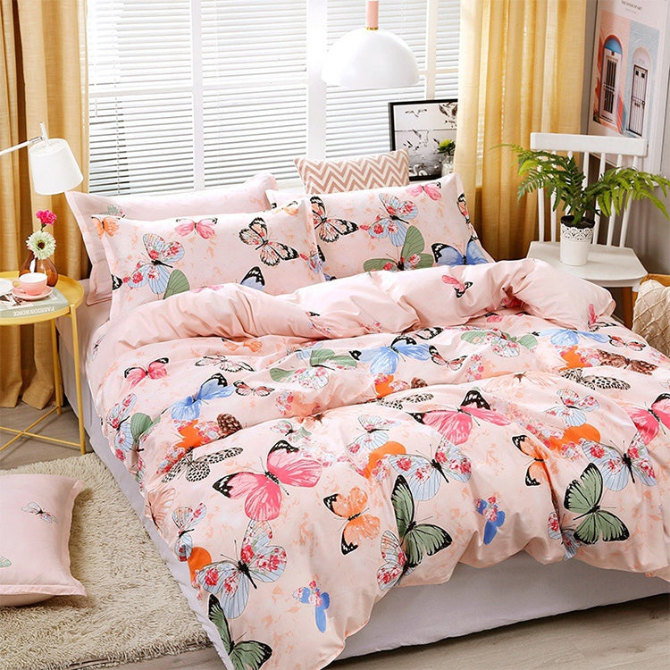 Light pink butterfly bedding set on a bed with two matching pillowcases