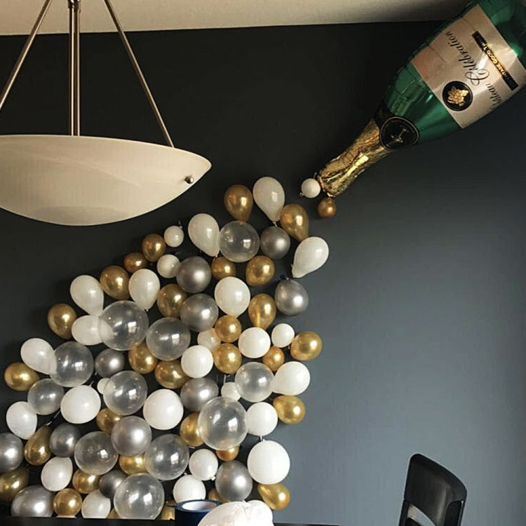 Champagne bottle foil balloon with gold, white, and silver latex balloon garland