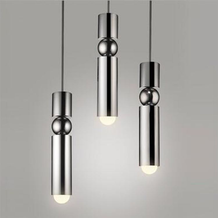 Silver three-light pendant chandelier with cylindrical shades and glowing bulbs