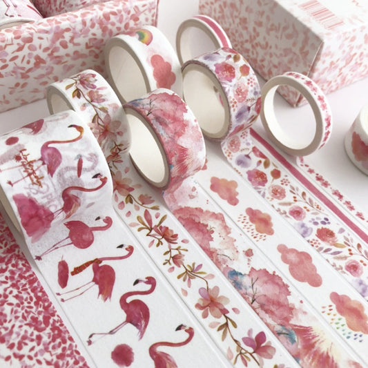 Decorative paper tape with pink floral and bird illustrations in rolled strips