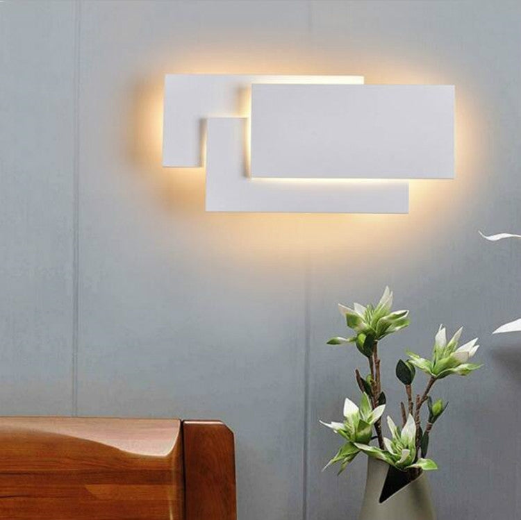 White LED wall lamp with layered rectangular panels and soft warm illumination